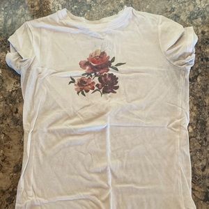 Small plain white shirt with flower patterns on front